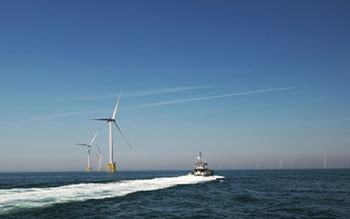 Marine ship sailing past East Anglia in background