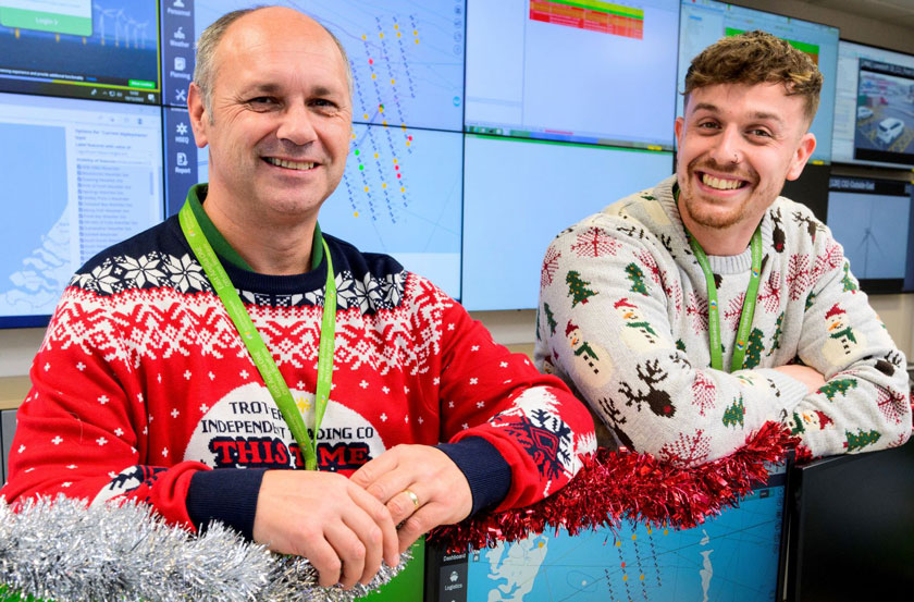 Richard and Adam smile for the camera in their christmas jumpers