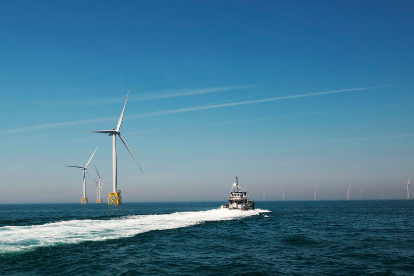 boat and wind turbines in open sea